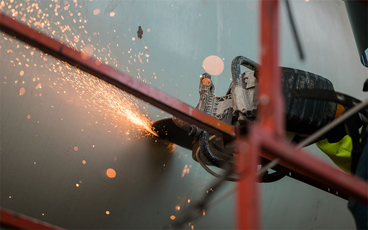 Close-up of machine cutting with sparks